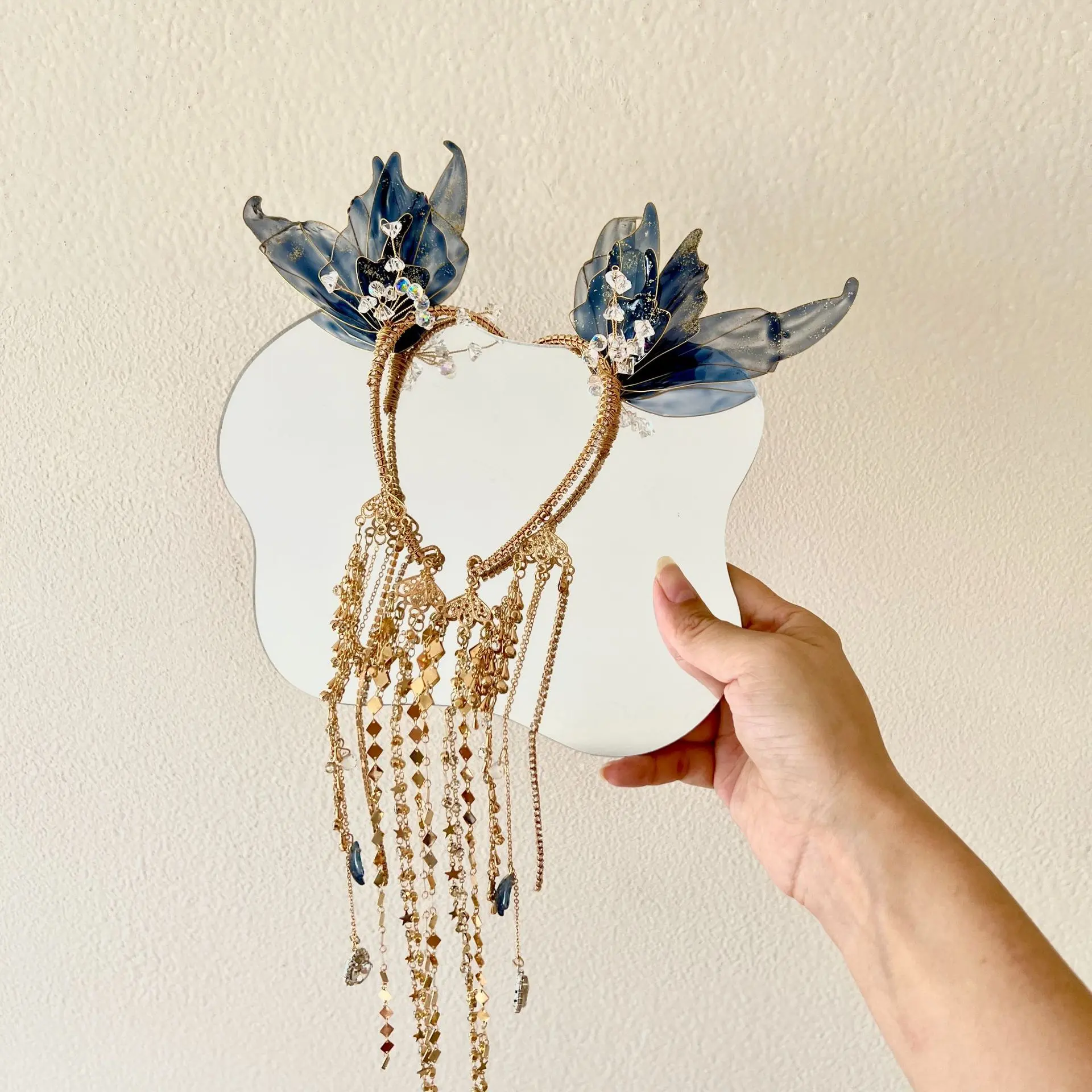 A pair of black, gold, and blue ear hook