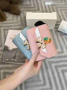 Cute baby dinosaur exquisite wallet with a green plant background, snap closure, card holder, available in multiple colors, the perfect Valentine's Day gift.