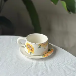 Handmade pottery coffee tea cup, mug with yellow orange sunflower. Flower ceramic tableware. Birthday, wedding, festival gift.