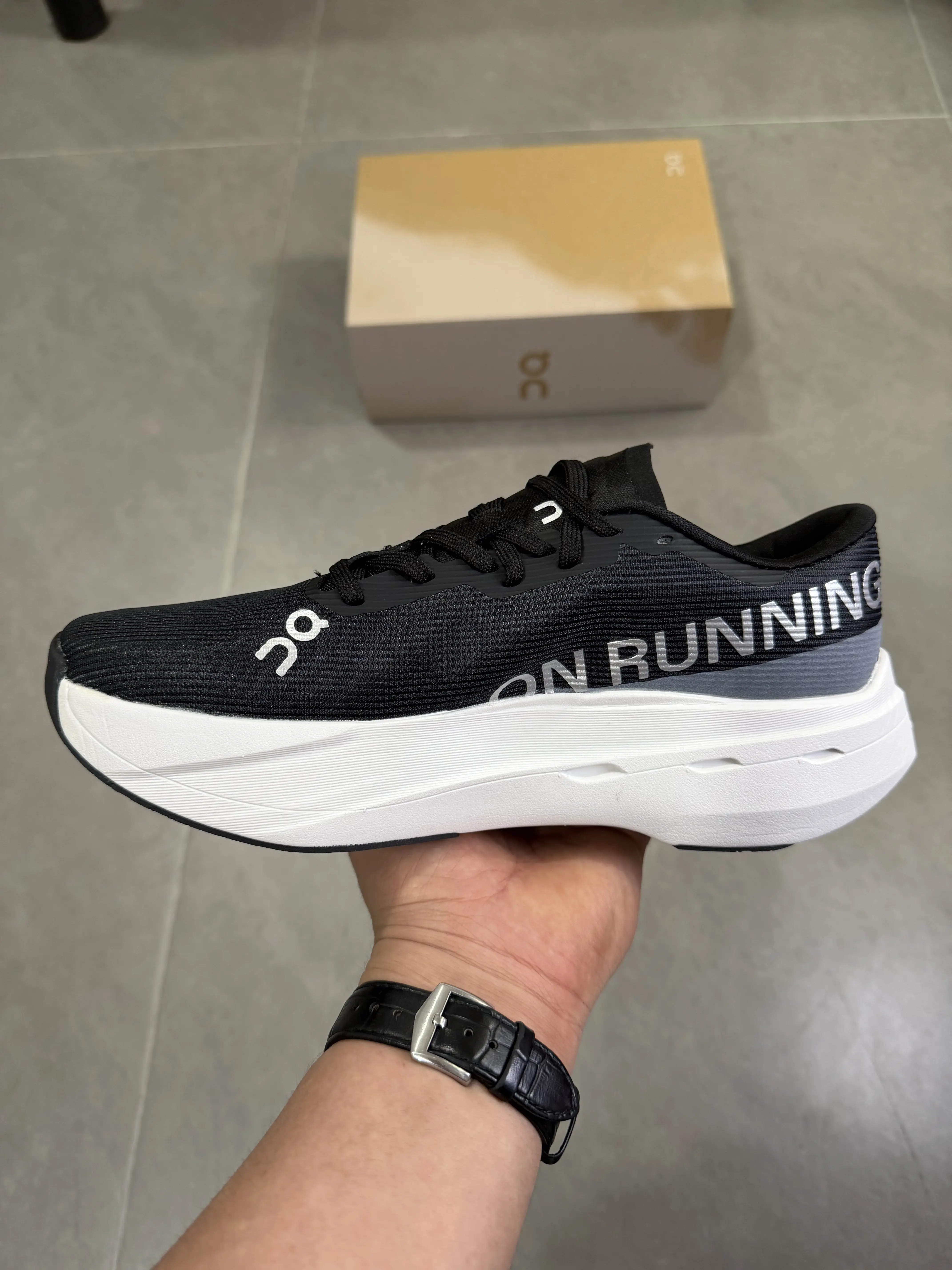 Running performance sneakers with layered high-elastic cushioned midsoles for long-distance stable shock absorption, premium sweat-wicking breathable knit mesh in solid black with bold white layered rubber outsole, textured gum rubber outsole