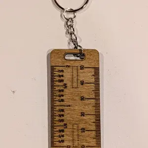 Ruler keychain with markings.