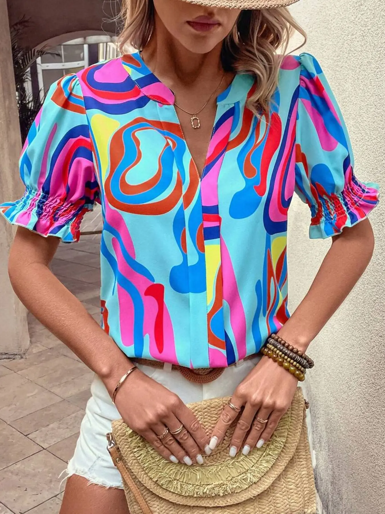 A women's colorful abstract print chiffon blouse shirts with puff sleeves, Boho Ruffle Sleeve, featuring a bright vintage summer style, V-neck opening, and short puff sleeves, suitable for vacation trips and casual everyday wear, Bohemian Casual Top