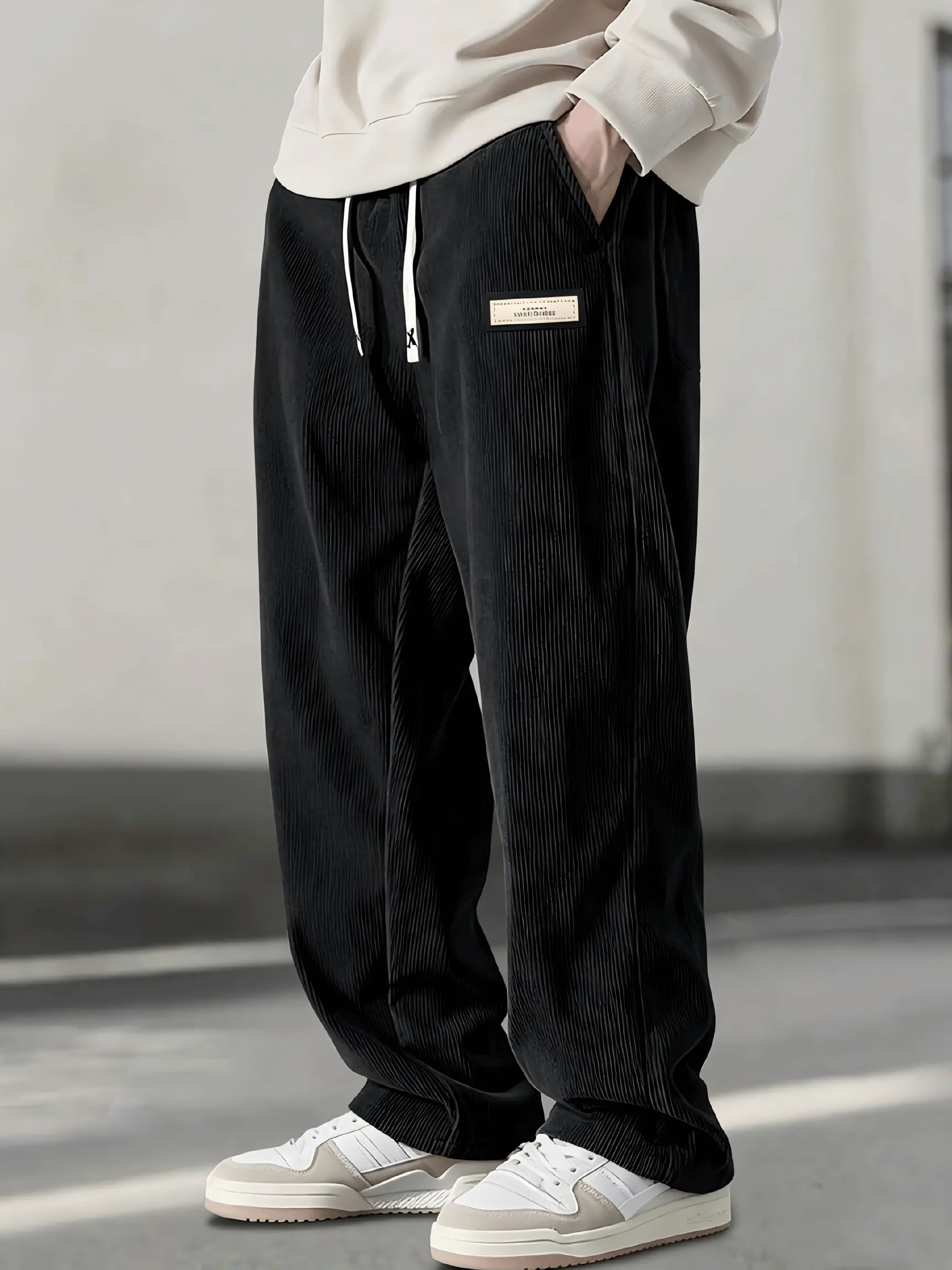 Men’s corduroy jogger pants, vintage loose fit casual trousers with an elastic drawstring waist and side pockets, streetwear label decor, striped texture sweatpants, versatile everyday outdoor hip hop fashion pants for fall/winter
