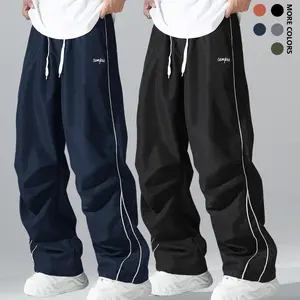 Men's relaxed and loose-fit drawstring pants with contrasting trim, lightweight and comfortable, suitable for both sports and casual wear.