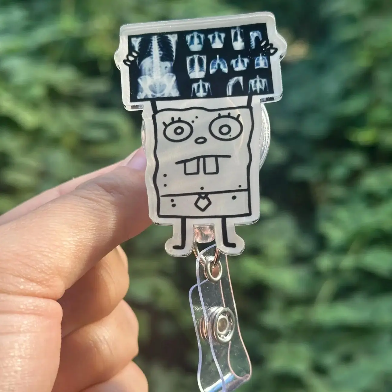 Cartoon Doodle holding Xray Badge Reel