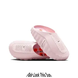 Streetwear casual slides featuring smooth molded foam upper, gentle blush pink contrasted by bold orange circular outsole grips, wavy rugged silhouette that elevates every soft-toned summer street outfit