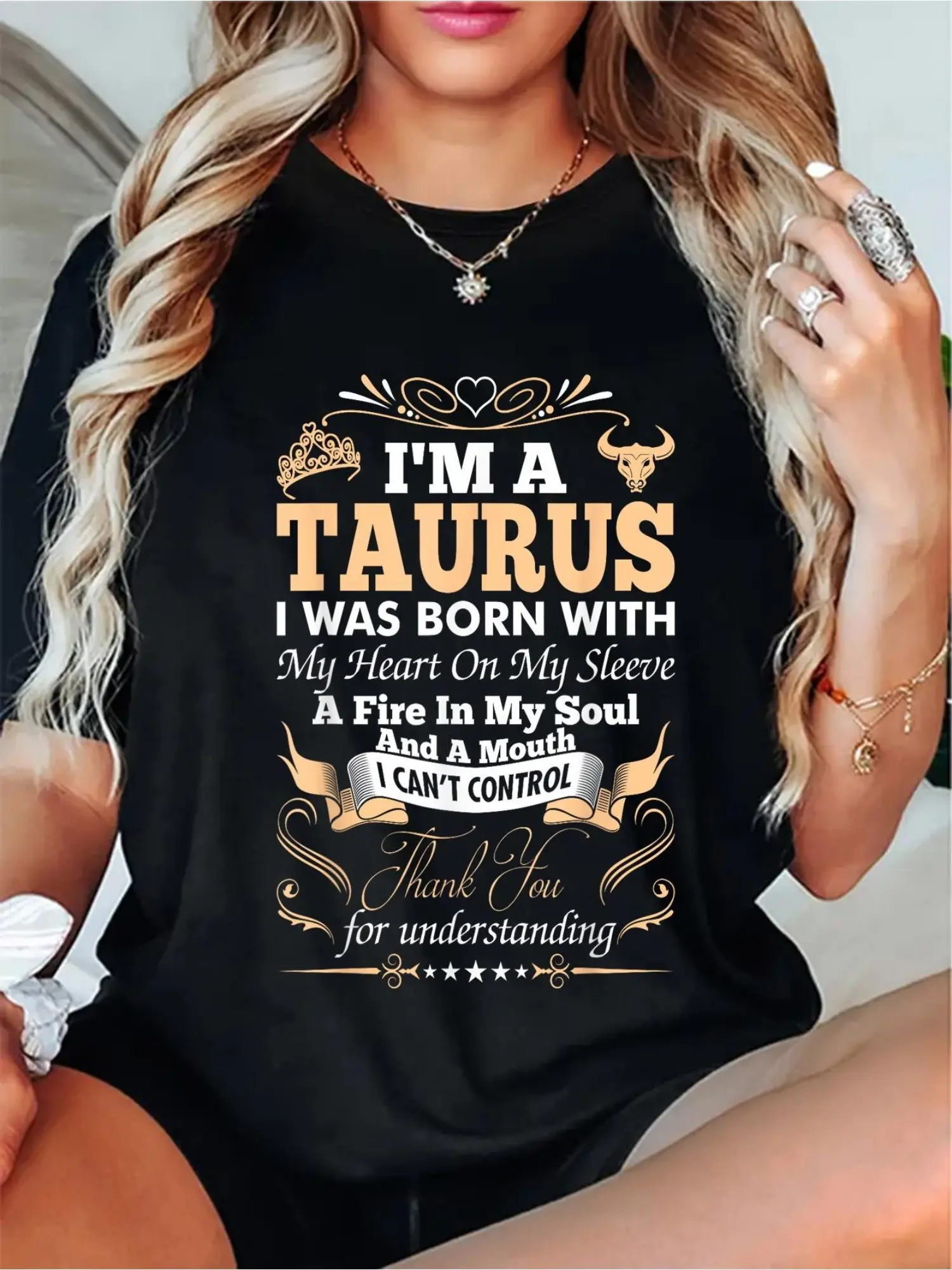A Women'S T-Shirt Showcasing a Taurus Design.It Features a Heart on The Sleeve, a Black Casual Top with Golden Text, a Cozy Crew Neck, Machine Washable, Ideal for Daily Wear As a Short-Sleeve Athletic Graphic Tee, Comfortable And Well-Fitted