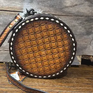 Brown leather crossbody bag with white stitching