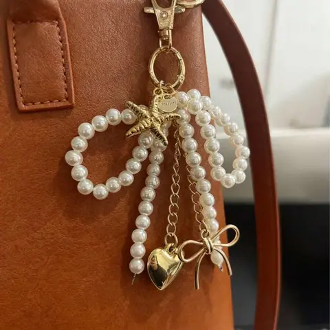 Gentle, exquisite pearl bead string decoration, embellished with starfish love bow design, can be used as keychain, Charms for bags, Trendy bag charms, Bag Accessories Charms, suitable for dates, shopping, parties