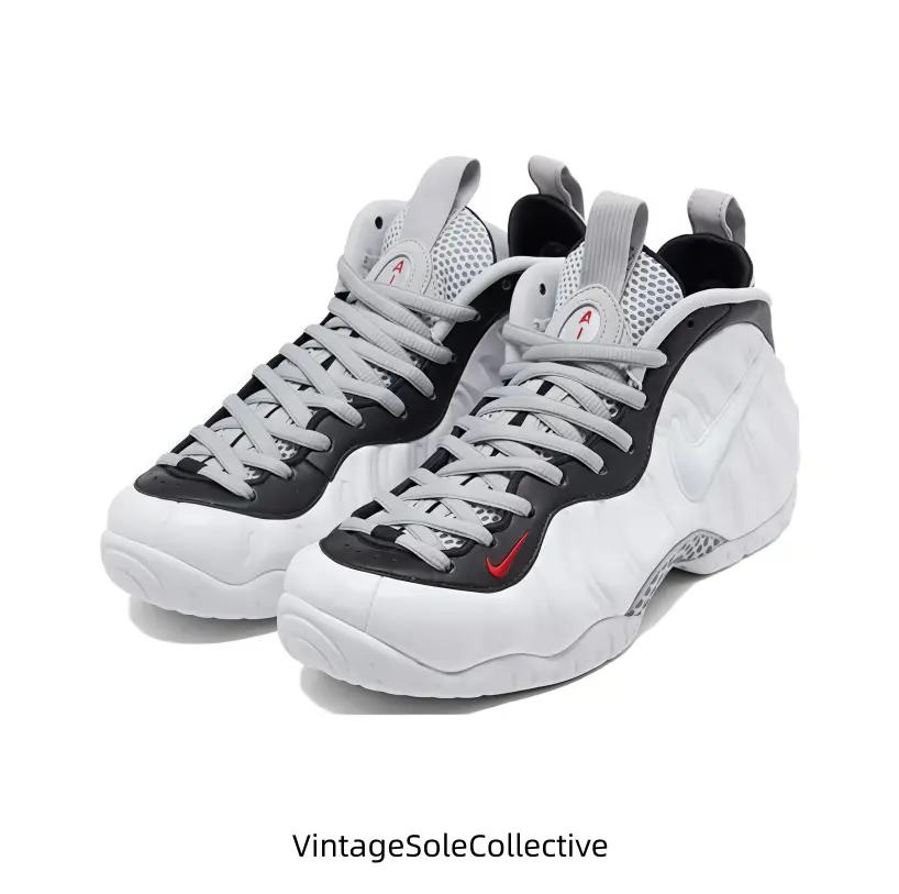 Clean white molded high-top sneakers with black collar panels and tiny red accent details, glossy ripple shell brings bright minimalist street aesthetic. White textured outsole delivers stable traction, padded ankle collar offers full support