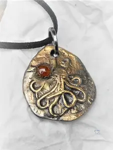 .999 Silver Kraken Pendant with Patina and Red Agate Cabochon.