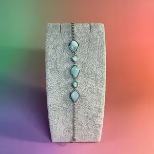 Genuine Larimar bracelet with five beautiful stones and set in 925 sterling silver!  This bracelet is adjustable!  The entire bracelets length is 8 inches but can be adjusted all the way down to 6 maybe 5 making it an absolute guarantee to fit!