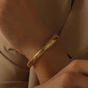 Exquisite twisted rope motif bold cuff bracelet available in gold or silver tone Waterproof Jewelry