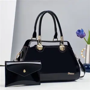 Dekerce Medium Satchel with Black Leather, Gold Accents, Two Handles, and Cross-body strap