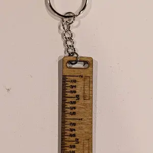 Ruler keychain with markings.