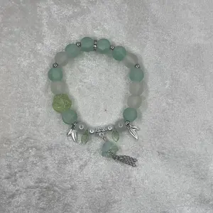 Green Matte Beaded Bracelet for Everyday Wear Charmed and Simple with Leaf and Feather Charms