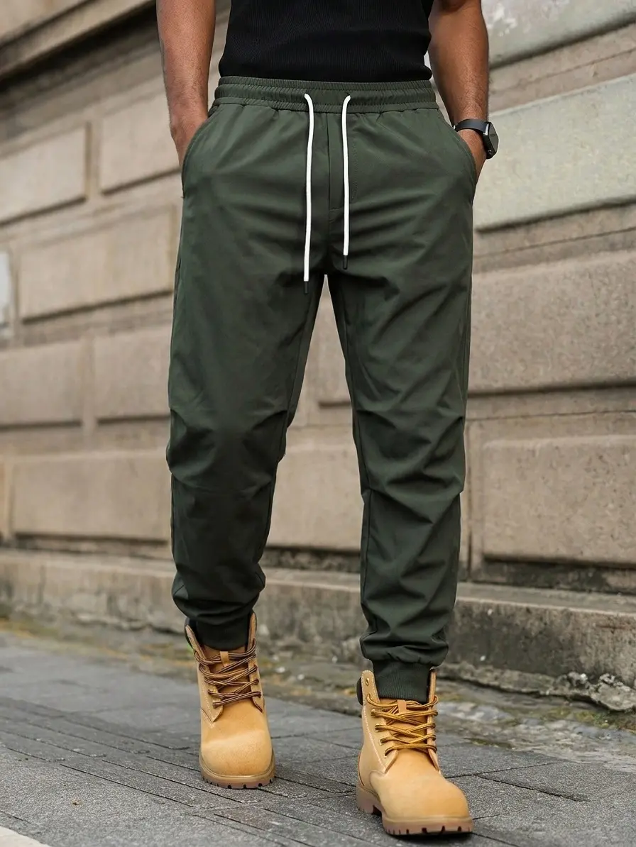 Men’s loose military green jogger pants made from breathable, quick-dry fabric that resists sweat, featuring a clean silhouette—designed for casual streetwear, commuting, weekends, and all-day comfort.
