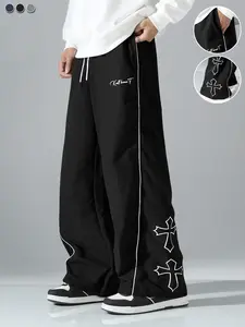 Men’s casual pants with cross embroidery, drawstring design for a stylish, versatile look, featuring reflective trim; suitable for everyday wear, beach trips, work, workouts, and more; spring/summer loose straight-leg pants.