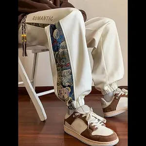 Men’s jogger pants with cartoon bear patchwork print, drawstring waist, regular fit, and pocket design—ideal for autumn and winter; fashionable men’s bottoms for everyday wear; streetwear joggers.