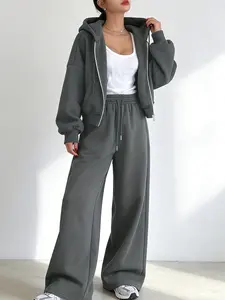 A two-piece set for women featuring a dark gray zip-up hoodie paired with matching wide-leg sweatpants for a streetwear casual look. The style is comfortable and relaxed, suitable for city shopping, daily commuting, or casual outings. Casual Lounge Set