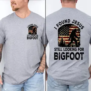 I Found Jesus Still Looking For Bigfoot Shirt, 2 Sided Funny Sasquatch Tee, Christian Patriotic American Flag TShirt, Humorous Bigfoot Believer Unisex Comfort Top
