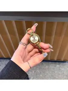 Minimalist golden horseshoe-shaped watch case for women, paired with a colorful dial and metal alloy strap. This stylish quartz watch is ideal for students to wear.
