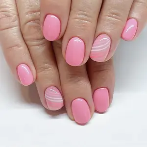 Chic Pink Bliss Nail Art – Soft, glossy pink nails with a playful twist, featuring delicate wavy white and pastel pink accent stripes. Perfect for adding a pop of color and charm to any look, this style blends sweetness and sophistication effortlessly