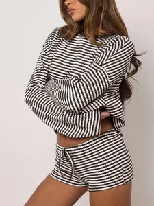 Two-piece women’s set featuring a two-tone American retro fine striped bubble knit: crewneck drop-shoulder cropped long-sleeve top + drawstring high-waisted shorts; relaxed home/casual loungewear sleepwear set.