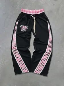 Mens black american high street track pants pink angel badge print with side pink white stripes and camouflage texture splicing design double waistband elastic drawstring loose wide leg fit breathable comfortable trendy casual sport sweatpants