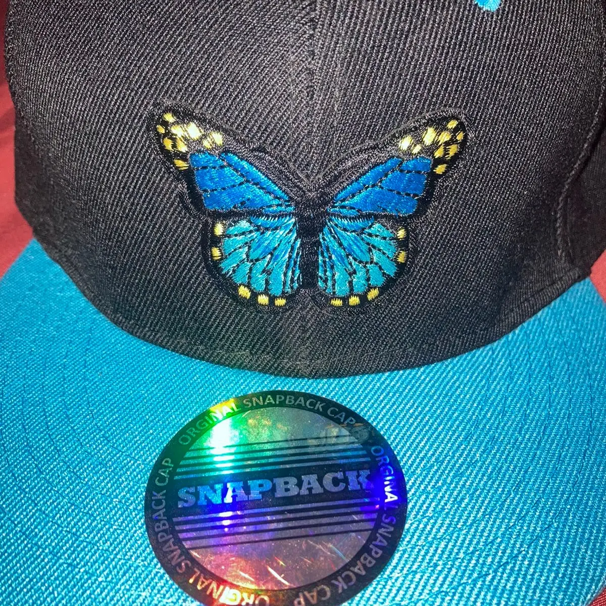 Blue and black orginal snapback with butterfly on it