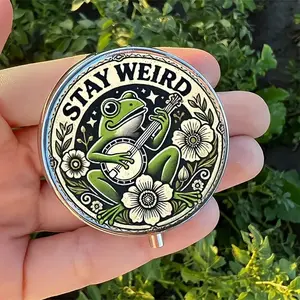 1pc Stay Weird Banjo-Playing Frog Round Pill Box, Compact 3 Compartment Vitamin Organizer, Durable Plastic Metal, Food Safe, Portable for Pockets Purses