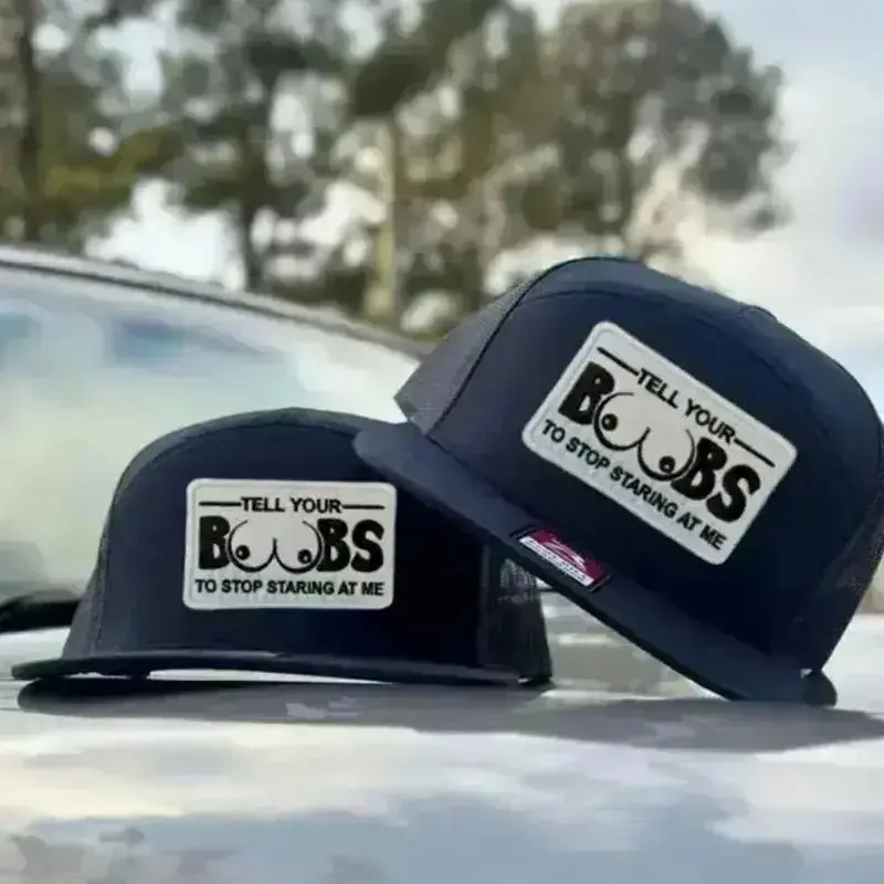 Funny "Tell Your Boobs to Stop Staring at Me" Trucker Hat | Adult Humor 7 Panel Mesh Snapback | Flat Bill Adjustable Cap | Gag Gift for Men