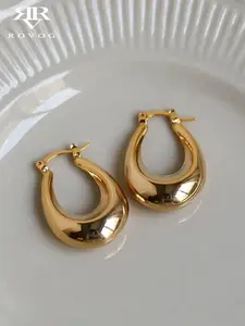 A pair of unique, individualistic, and cool style teardrop-shaped ear rings with a metallic texture that are highly versatile and fashionable for women