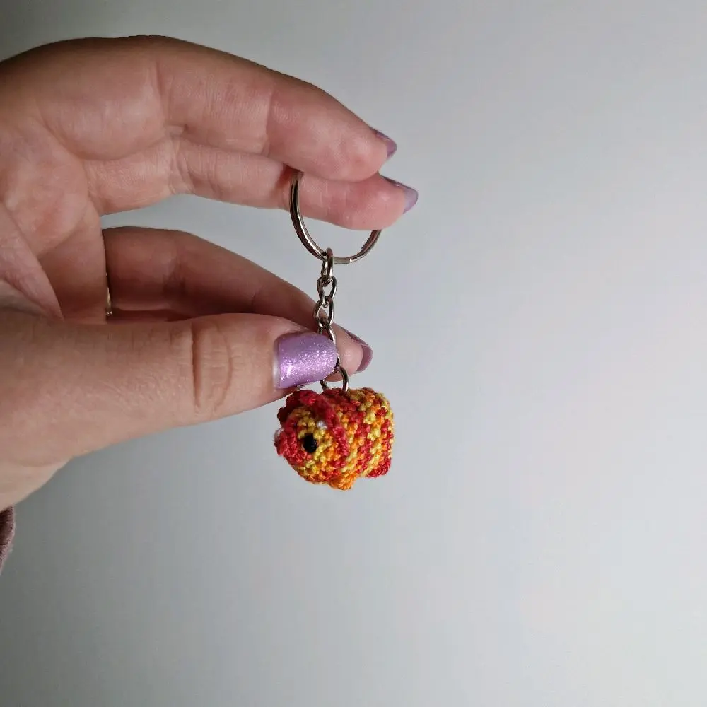 Handmade plushie triceratops dinosaur variegated red, yellow and orange crochet amigurumi - microcrochet keyring