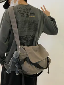 Suitable for men and women Plain Canvas Crossbody Bag,Lightweight Crossbody Bag,Solid Color Trendy Versatile Bag with Cartoon Charm,Large Capacity Daily Commuting Shoulder Bag for Work & School