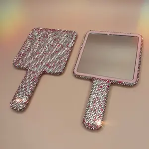 Pink and silver hand mirror