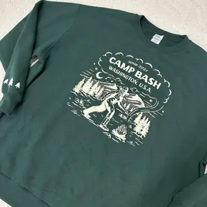 Port & Company Camp BASH Bigfoot Evergreen Crewneck Sweatshirt – PNW Sasquatch Camping Graphic All Seasons Unisex Fit Soft Fleece