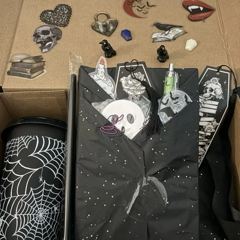 Macabre Book Club Blind Box - Each box contains a used horror book with 7-10 spooky items.  Perfect for your ghoulish friend in time for Halloween