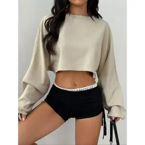 Women’s beige cropped long-sleeve sweatshirt, loose fit, casual streetwear, Y2K autumn fashion top, fashionable minimalist aesthetic, soft fabric, comfortable sportswear GARMENTARY