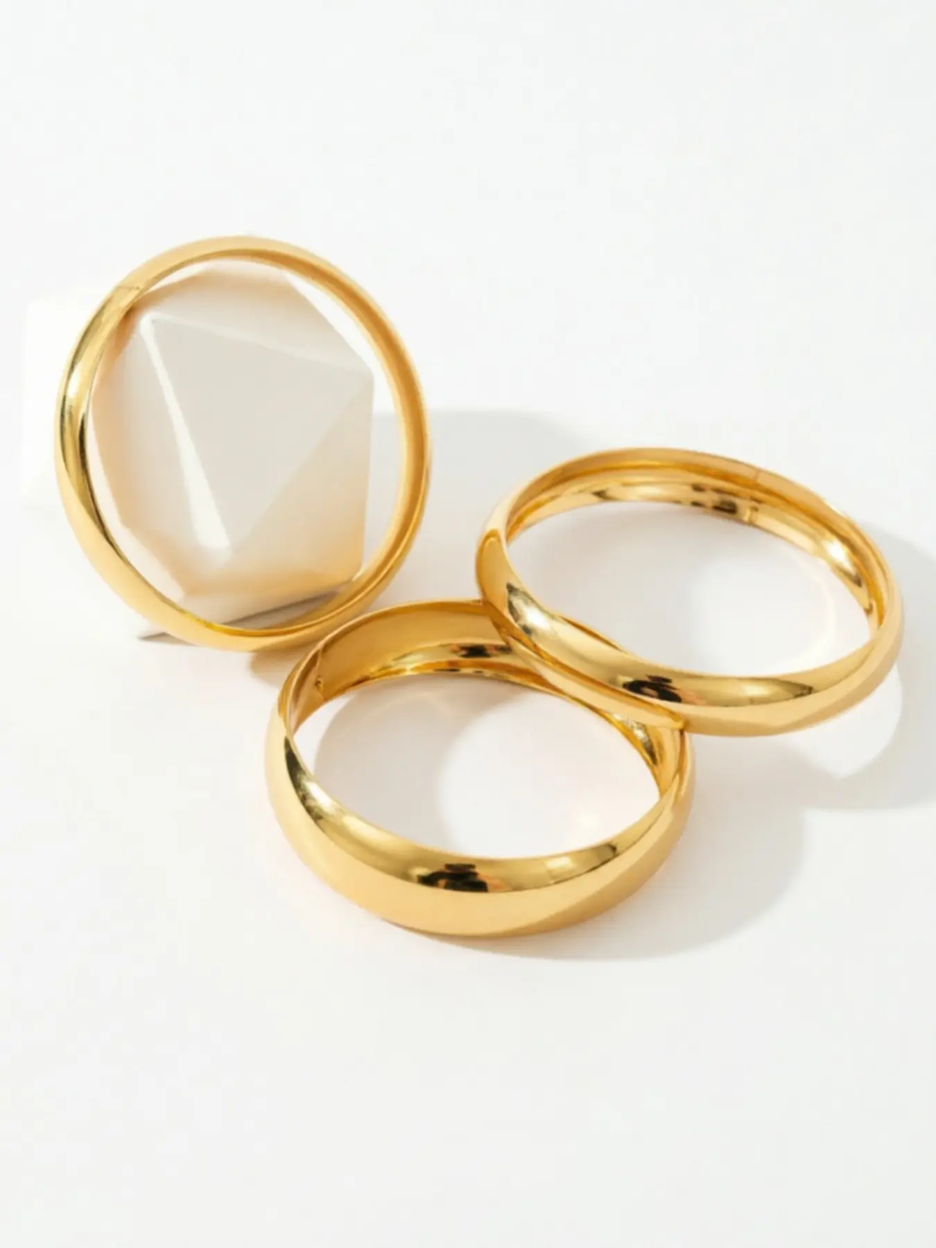 This three-piece bracelet set is vintage and versatile, featuring stackable gold bracelets that are perfect for everyday wear.