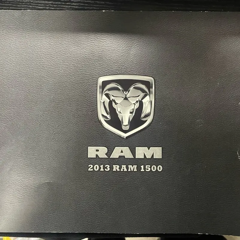 RAM 2013 RAM 1500 Black Sales Brochure Booklet with Genuine Logo Silver Embossed Lettering and Emblem Sleek Textured Surface