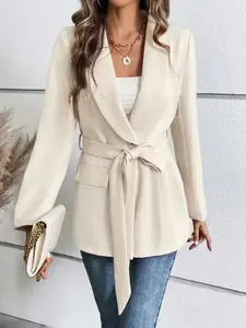 A ladies' peach-colored collarless fitted blazer with belt, featuring a simple style and versatile appeal for casual wear.