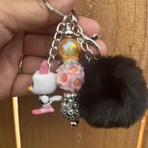 Character Keychains with Unique Design Featuring a Black Fur Ball and Decorative Beads