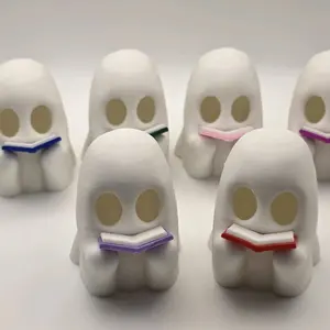 Readings Ghost Figurine - White Characters with Circular Eyes and Colorful Books Displayed