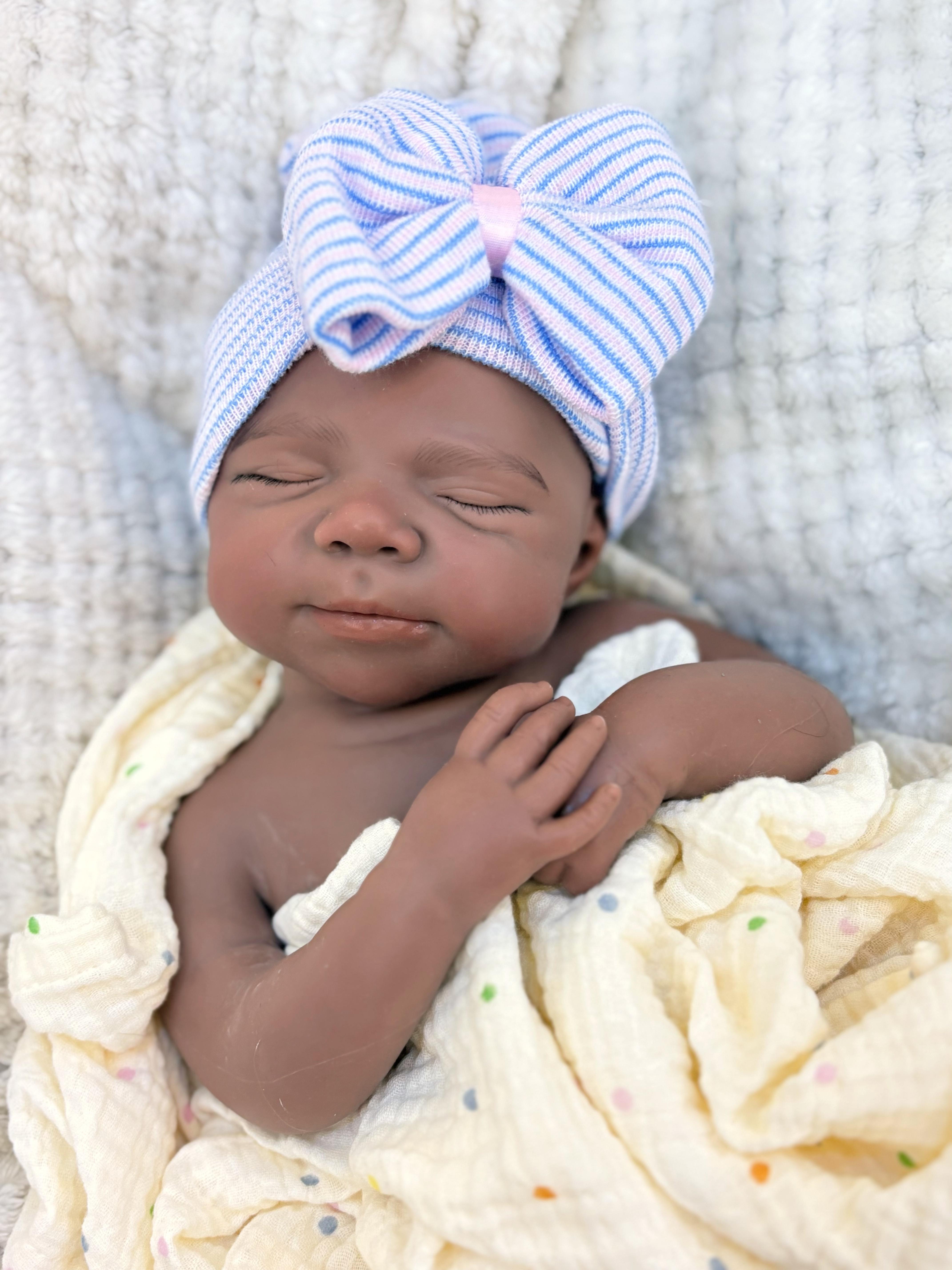 Reborn doll, soft silicone — 18 inches tall, lifelike with closed eyes for sleeping, brown skin, a soft body, and realistic detailed features. Includes a comfort item, a bottle, and a birth certificate. Perfect for birthday gifts, collectors, and children
