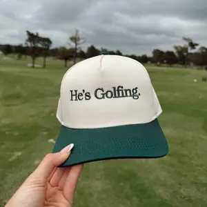 He's Golfing - Green Vintage Trucker Hat