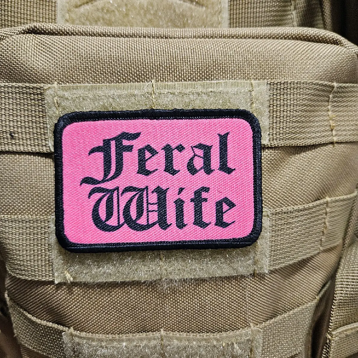Feral wife meme 2"x3" morale patch with hook and loop backing black on pink