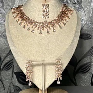 Aarna Rose Gold Cubic Zirconia Jewelry Set with Earrings and Mangtika