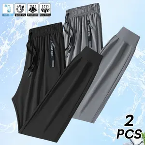 Men’s lightweight ice silk casual pants, 2-pack, featuring large zippered pockets and a drawstring waist; breathable, stretchy ice silk pants with a minimalist solid color and cuffed hems.