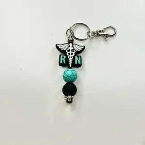 Cute trendy RN registered nurse keychain turquoise and black silicone beads. Beaded bar measures 3-1/2 inches long.